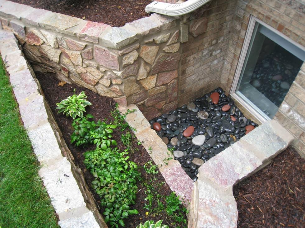 Egress window well splitting a garden