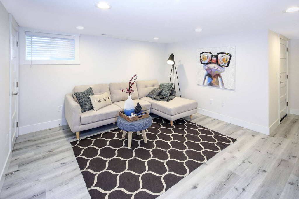 A renovated bright basement with an egress window